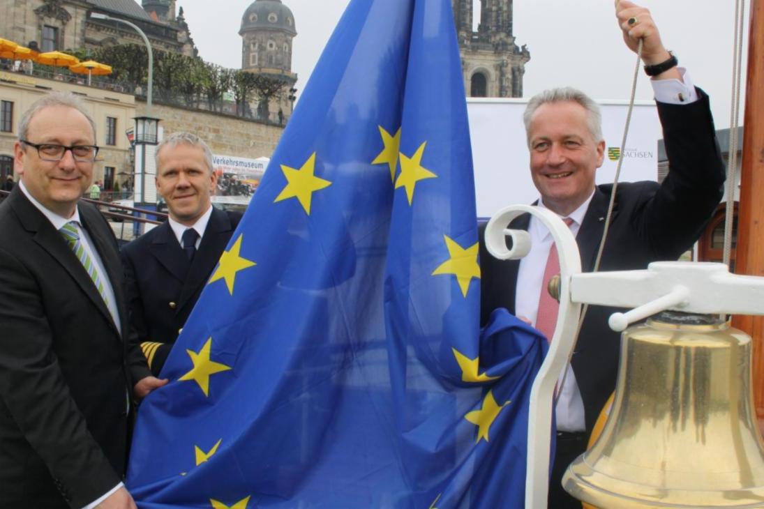 Anlässlich der Europawoche hat der sächsische Europaminister Dr. Jürgen Martens heute gemeinsam mit dem Geschäftsführer der Sächsischen Dampfschiffahrtsgesellschaft Dr. L. Sebastian Meyer-Stork symbolisch die Europaflagge auf dem Personenraddampfer „Dresden“ gehisst.
v.l.n.r.: Justizminister Dr. Jürgen Martens, Kapitän Andreas Weber, Geschäftsführer der Sächsischen Dampfschiffahrtsgesellschaft Dr. L. Sebastian Meyer-Stork 